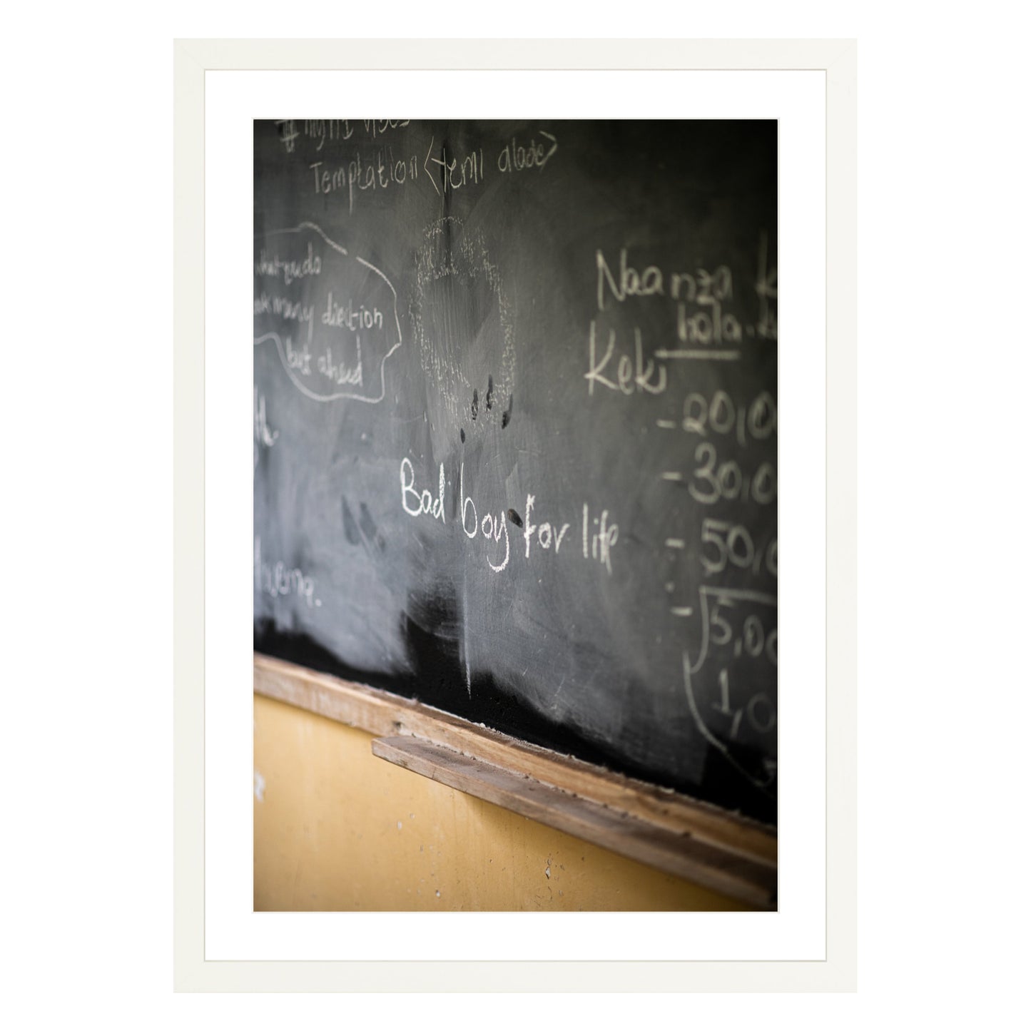 Photograph of chalkboard with "bad boy for life" written on it framed in white with white mat