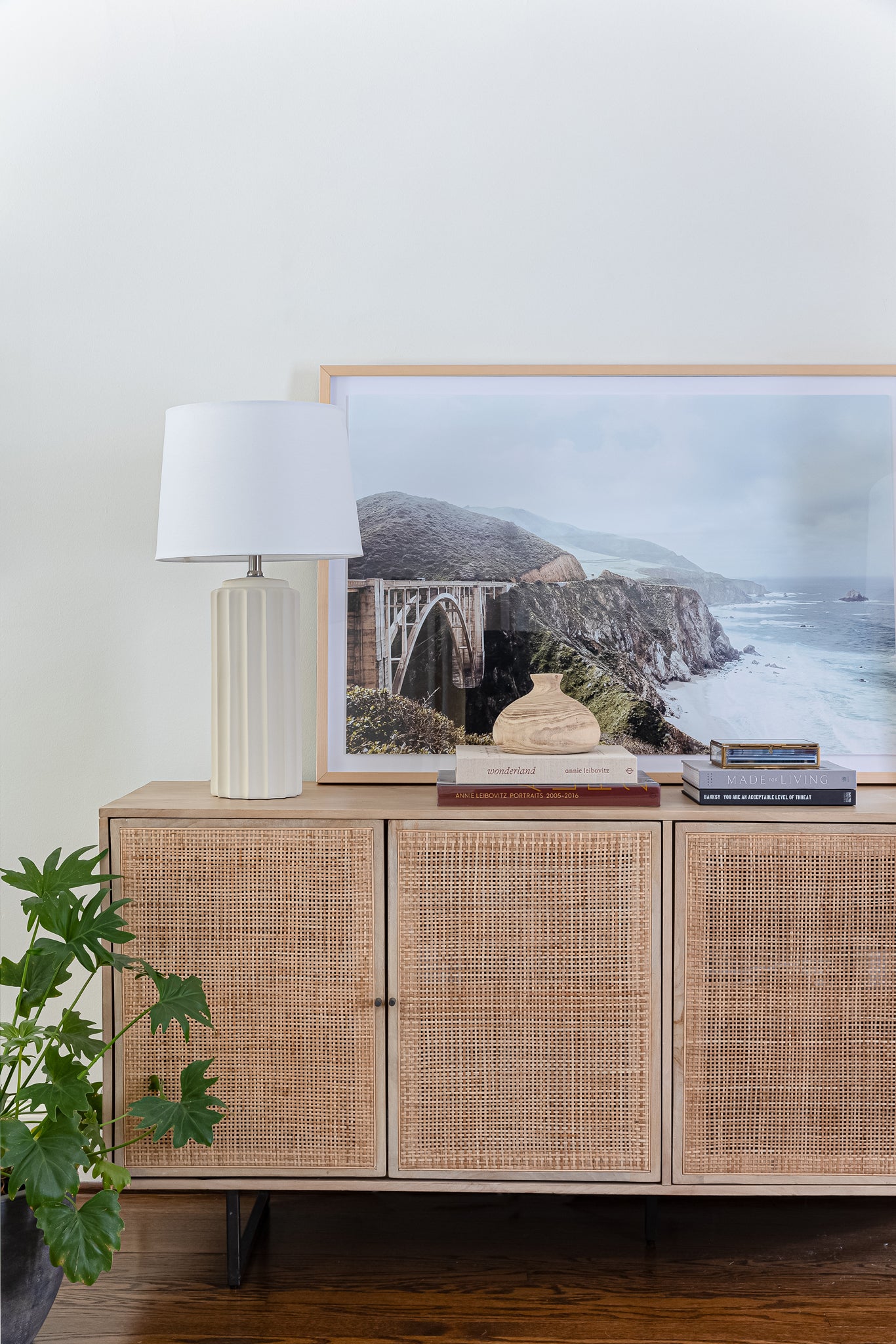 Bixby Bridge framed print on console table with books and lamp