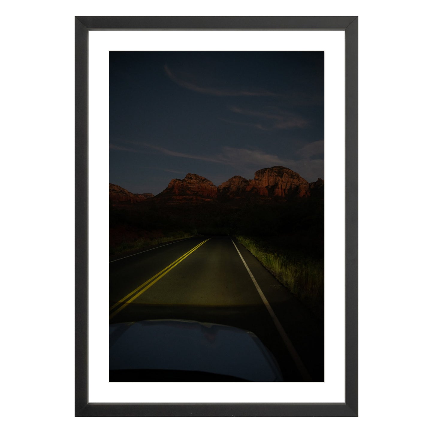 Photograph of a highway and mountains at night in Sedona Arizona framed in black with white mat