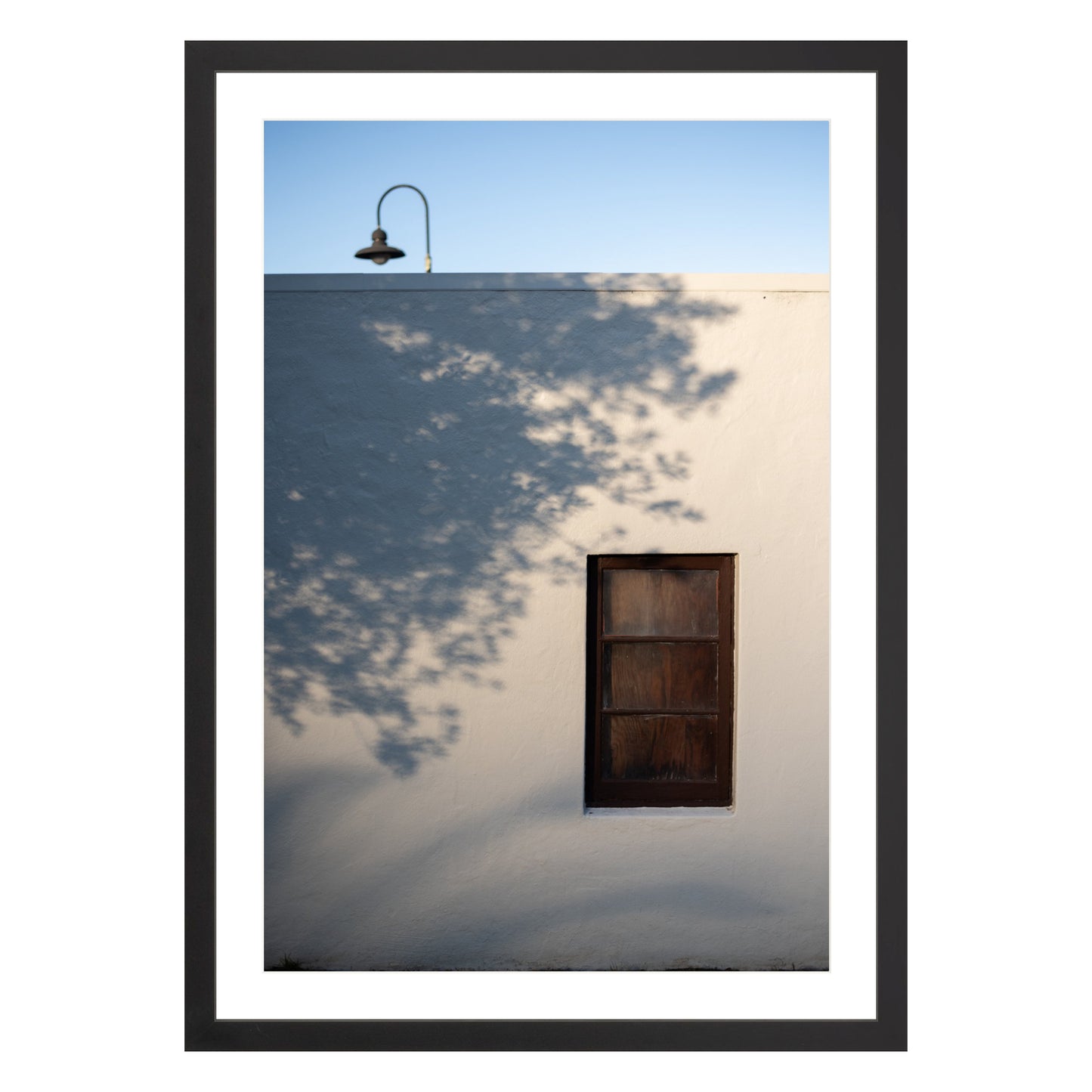 Photograph of shadows on building in San Francisco Presidio in black frame with white mat