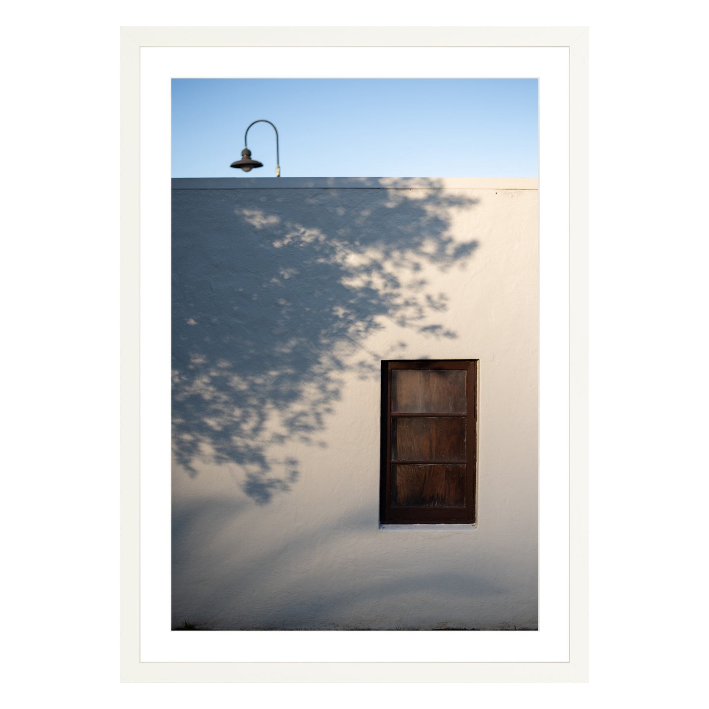 Photograph of shadows on building in San Francisco Presidio in white frame with white mat