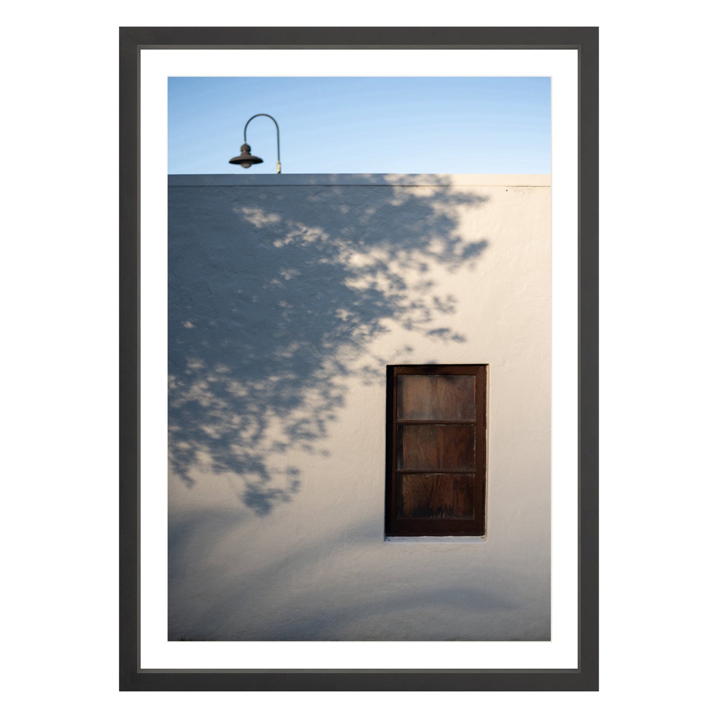 Photograph of shadows on building in San Francisco Presidio in black frame with white mat