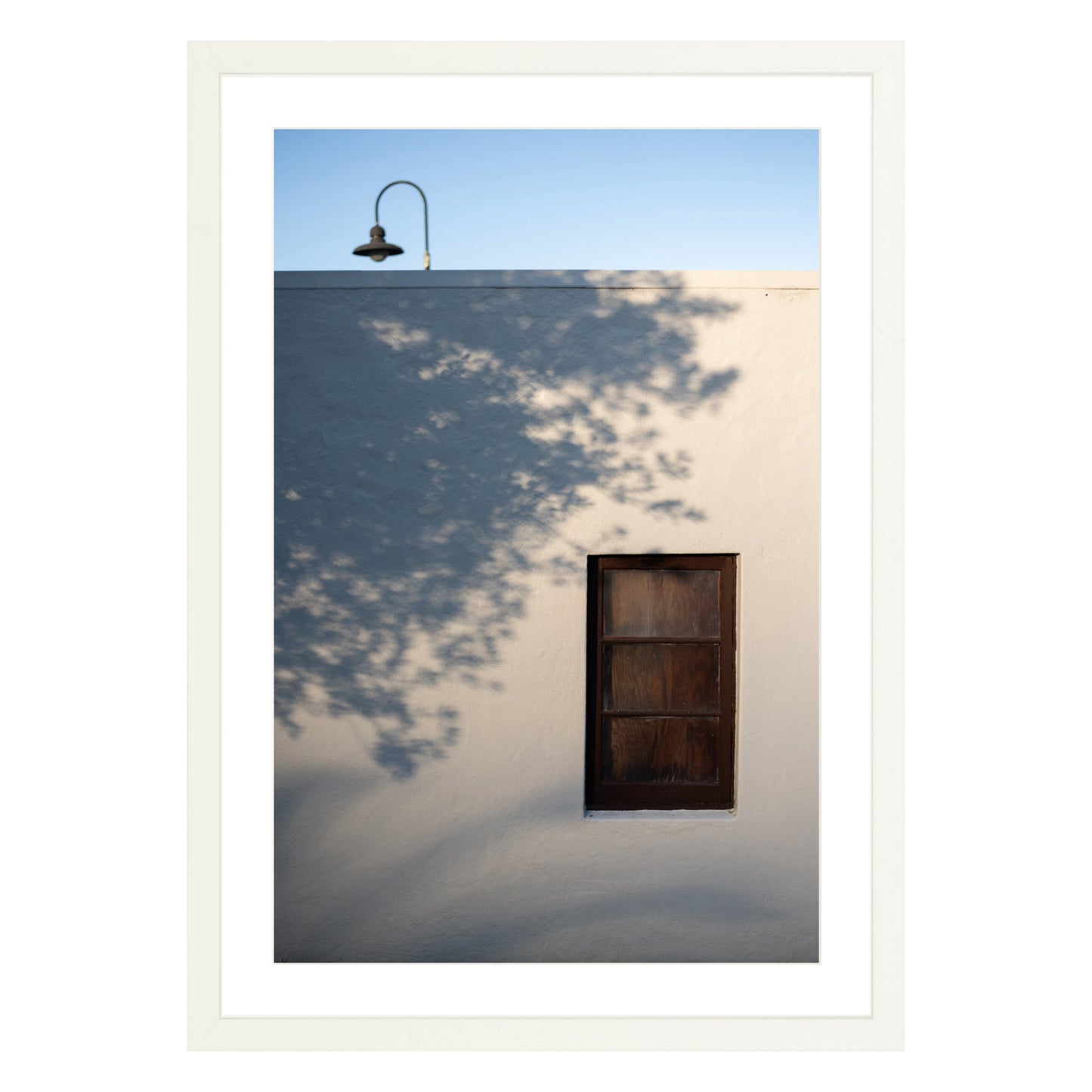Photograph of shadows on building in San Francisco Presidio in white frame with white mat