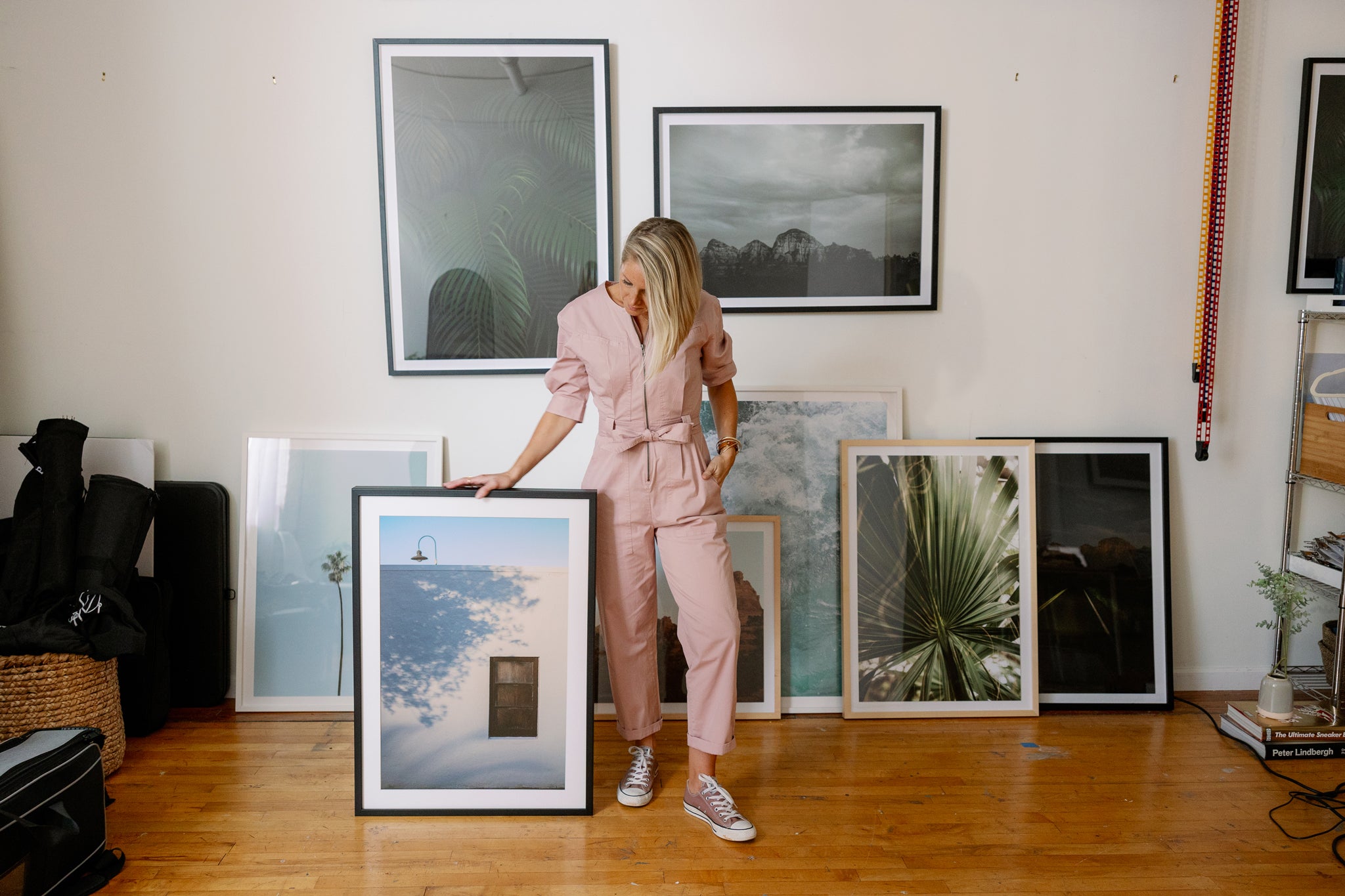 Photographer Amanda Anders in her studio with framed prints