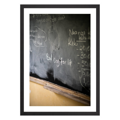 Photograph of chalkboard with "bad boy for life" written on it framed in black with white mat