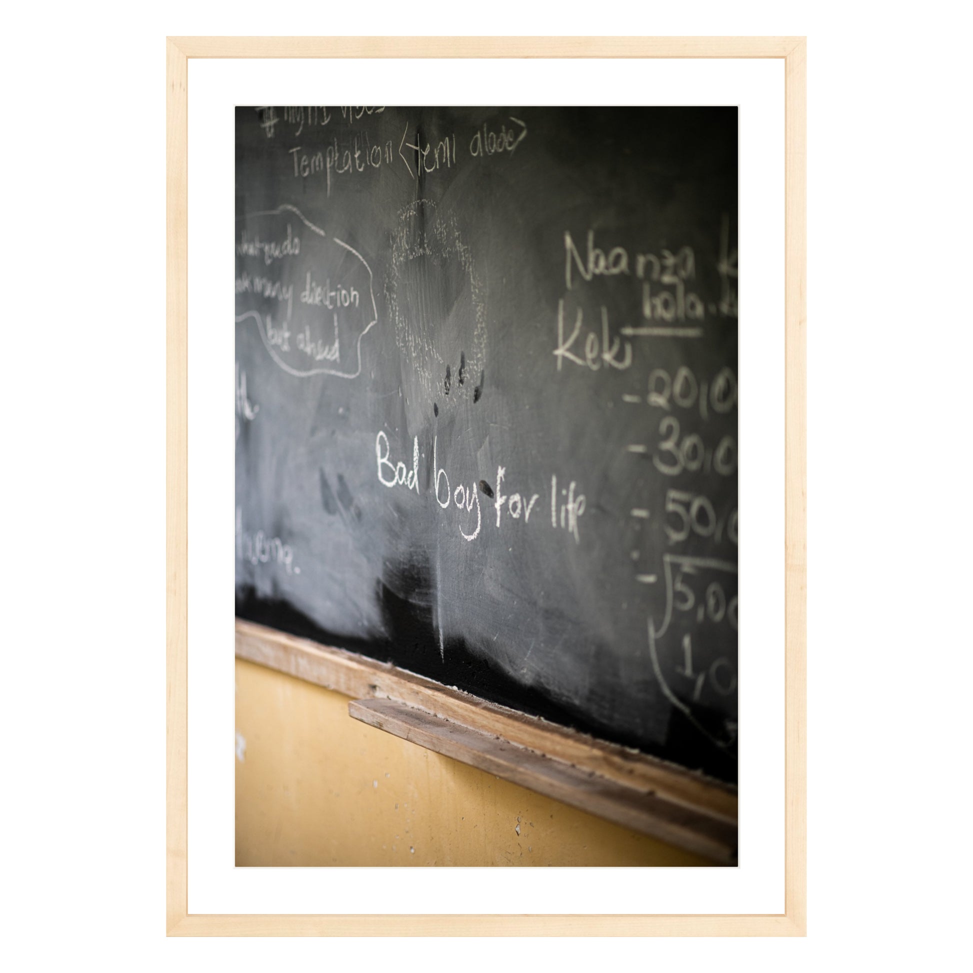 Photograph of chalkboard with "bad boy for life" written on it framed in natural wood with white mat