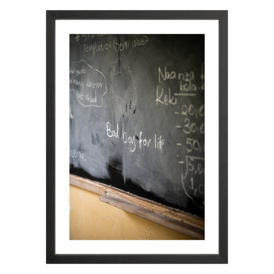 Photograph of chalkboard with "bad boy for life" written on it framed in black with white mat