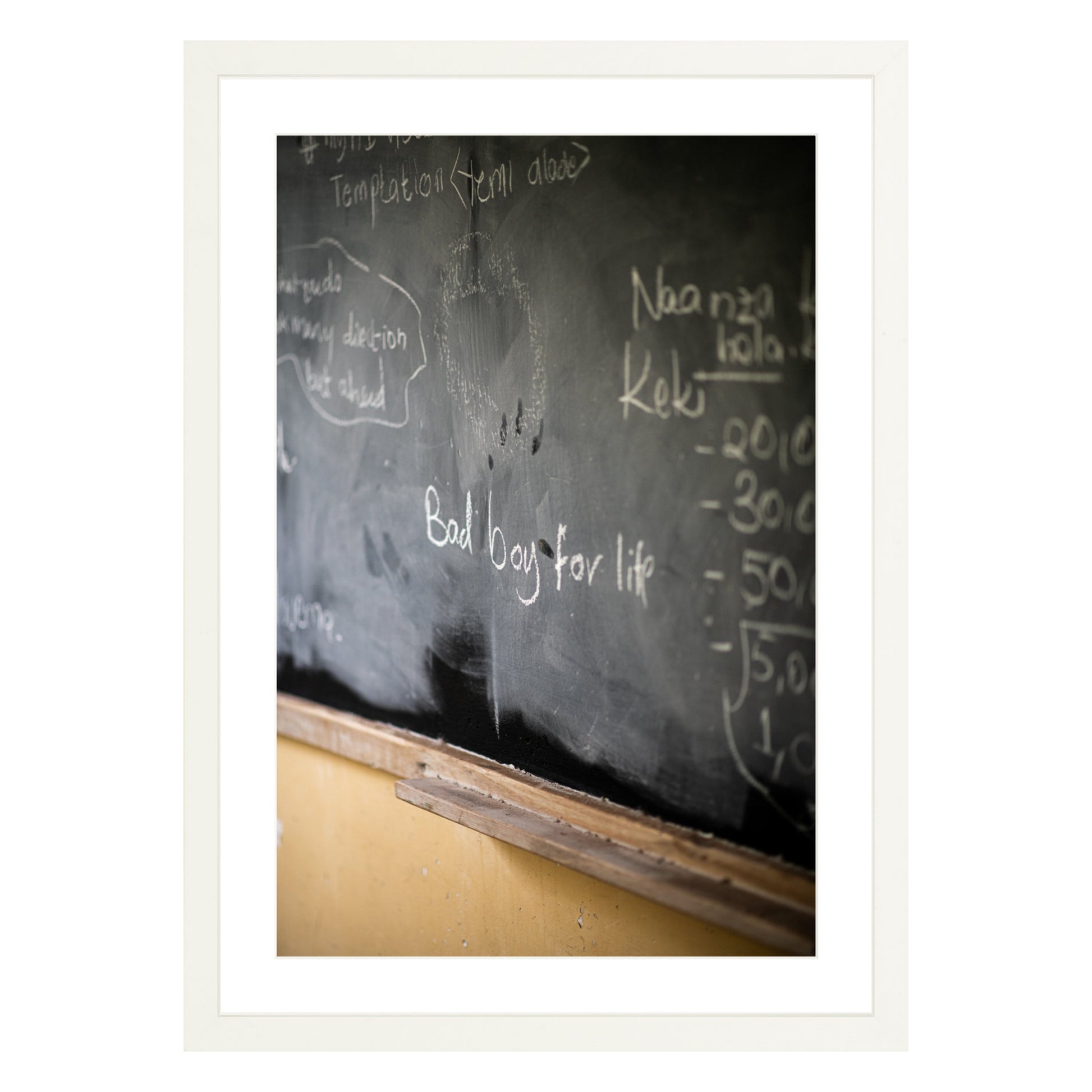 Photograph of chalkboard with "bad boy for life" written on it framed in white with white mat
