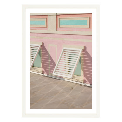 Photograph of colorful geometric building with open window shades in Baha Mar, Bahamas framed in white with white mat