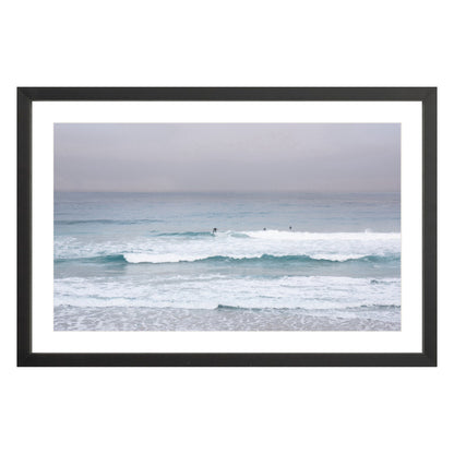 Photograph of surfers on Carmel coast, California framed in black with white mat