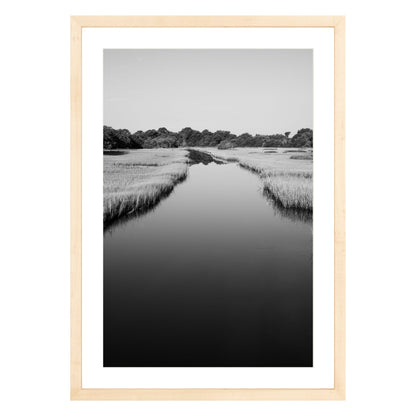 Black and white photograph of a marsh stream on Kiawah Island, South Carolina framed in natural wood with white mat