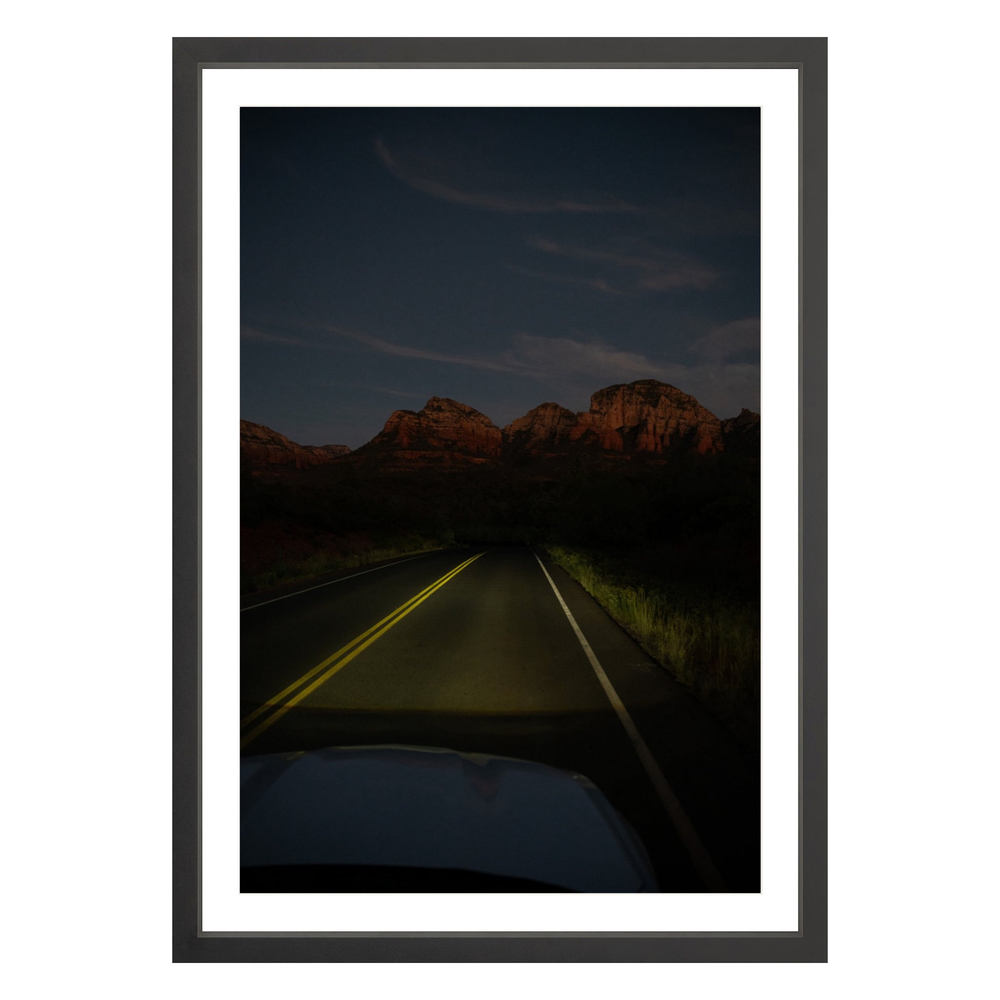 Photograph of a highway and mountains at night in Sedona Arizona framed in black with white mat