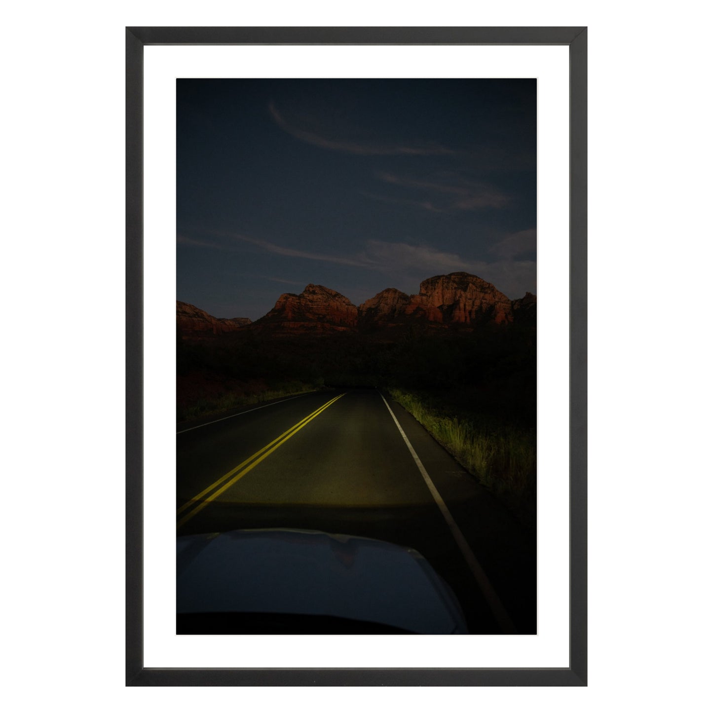 Photograph of a highway and mountains at night in Sedona Arizona framed in black with white mat