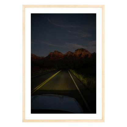 Photograph of a highway and mountains at night in Sedona Arizona framed in natural wood with white mat