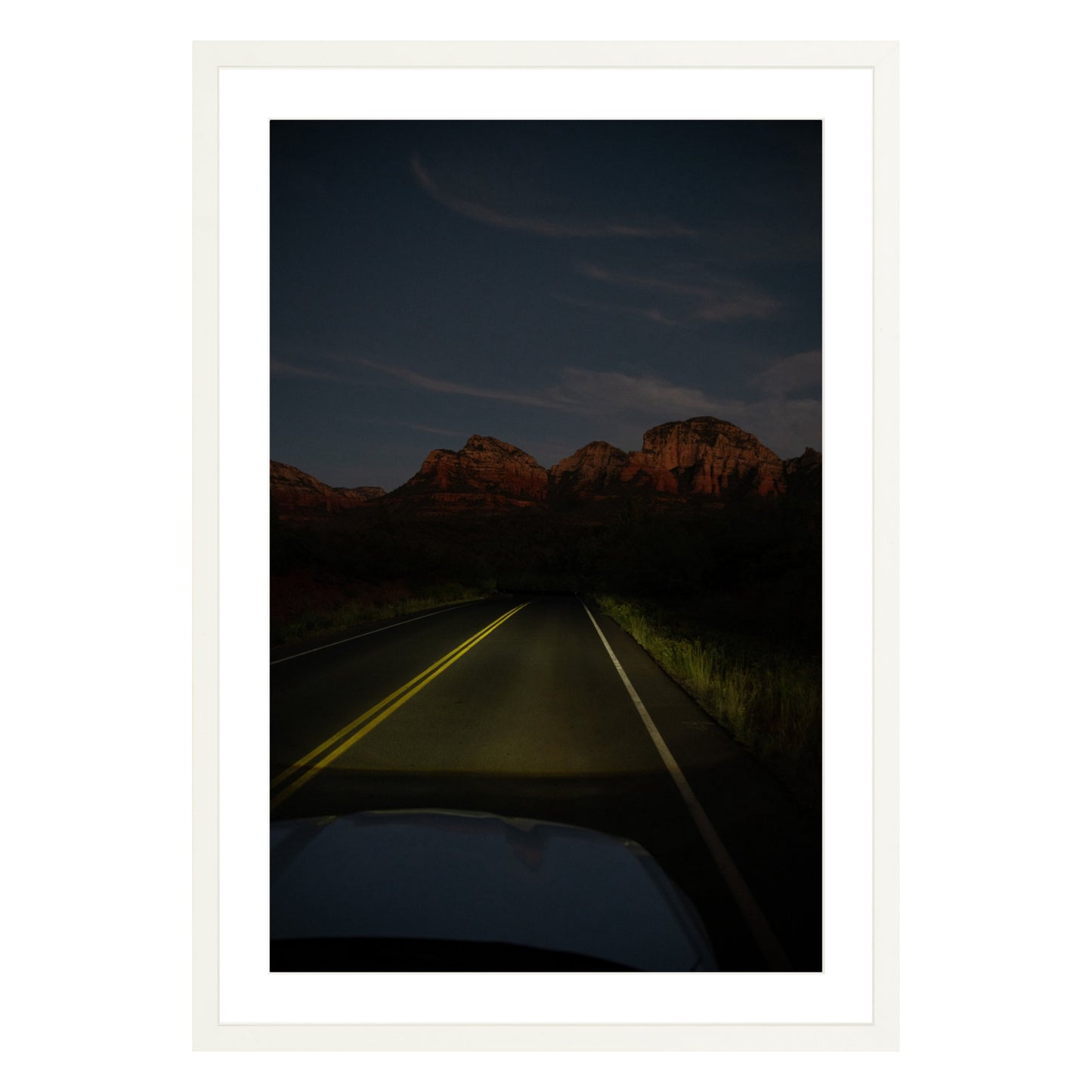 Photograph of a highway and mountains at night in Sedona Arizona framed in white with white mat