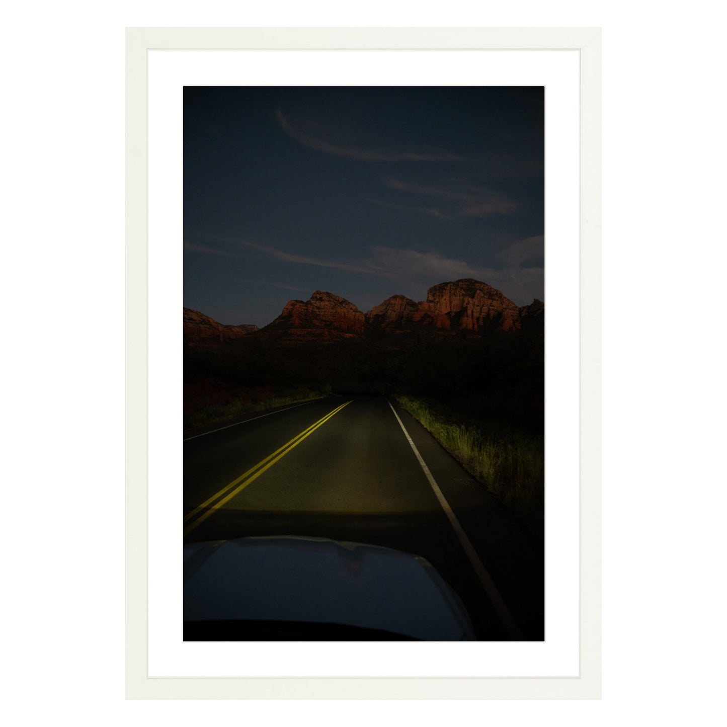 Photograph of a highway and mountains at night in Sedona Arizona framed in white with white mat