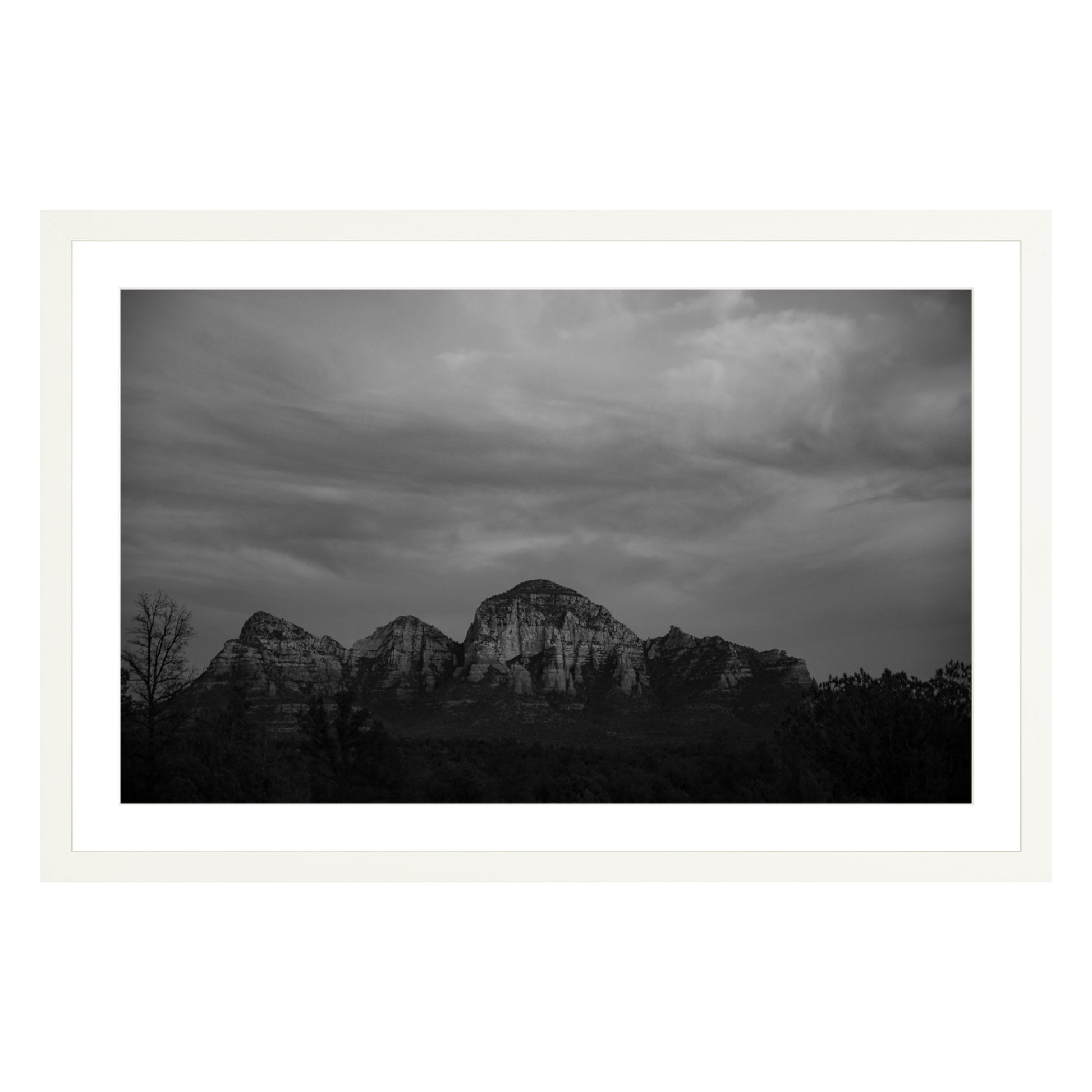 Black and white photograph of mountains in Sedona Arizona at night in a white frame with white mat