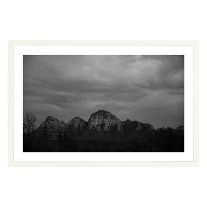 Black and white photograph of mountains in Sedona Arizona at night in a white frame with white mat