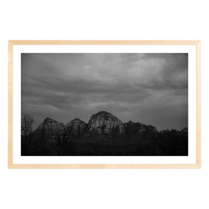 Black and white photograph of mountains in Sedona Arizona at night in a natural wood frame with white mat