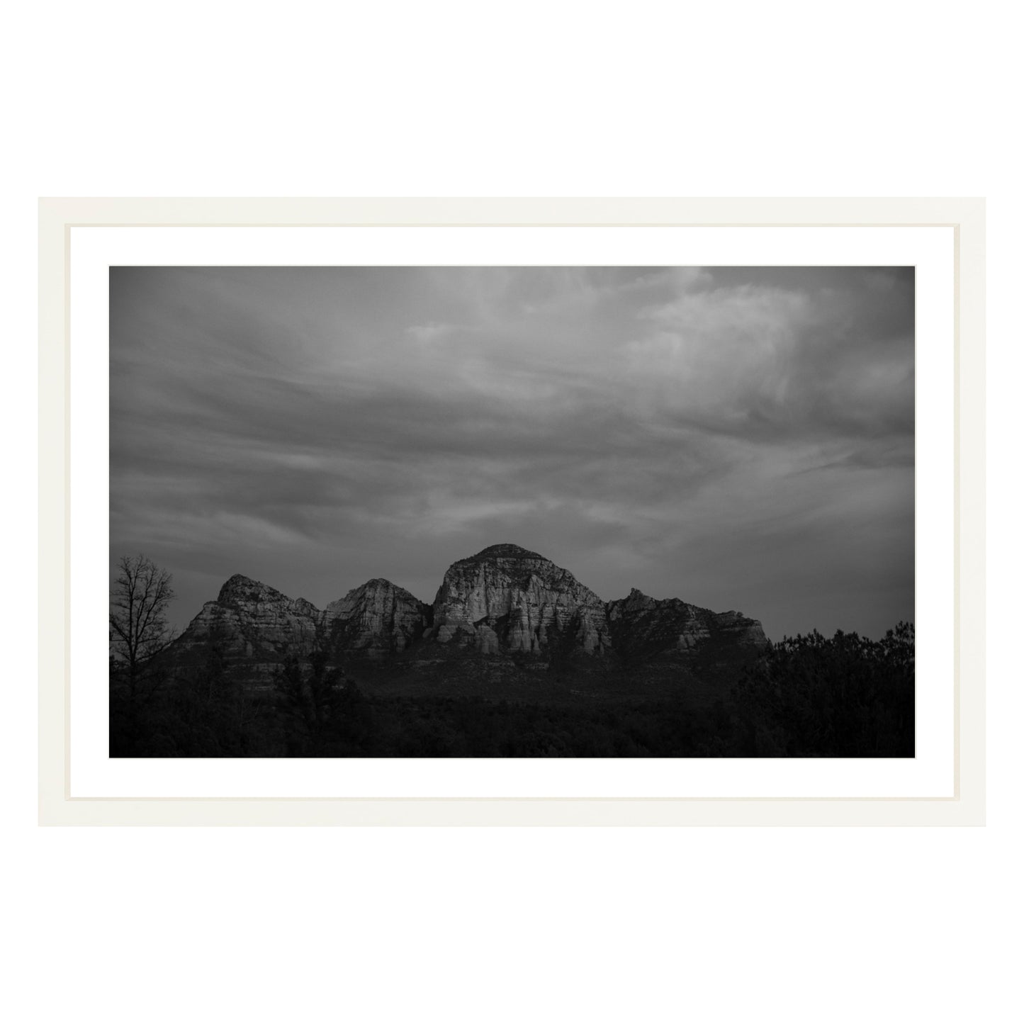 Black and white photograph of mountains in Sedona Arizona at night in a white frame with white mat