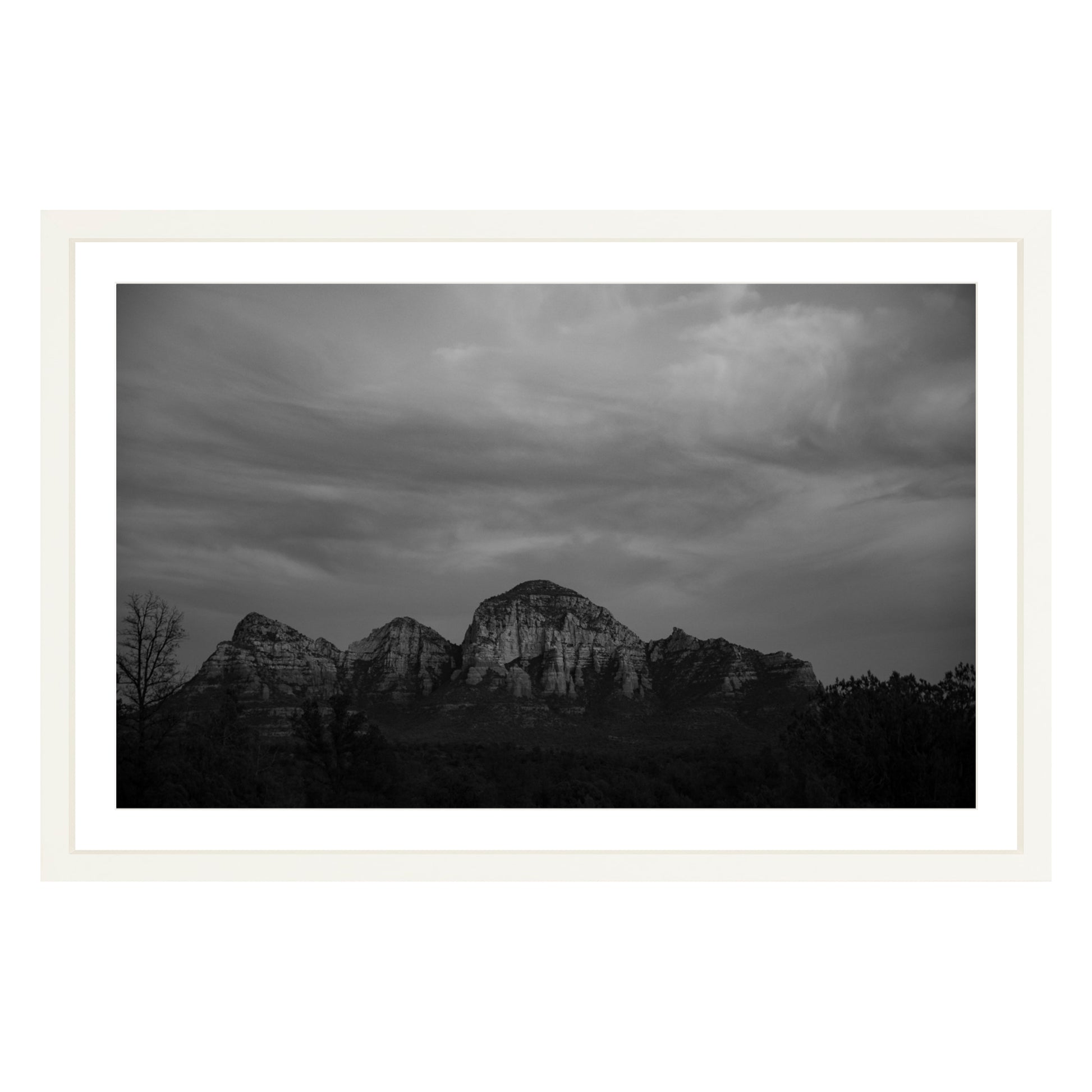Black and white photograph of mountains in Sedona Arizona at night in a white frame with white mat