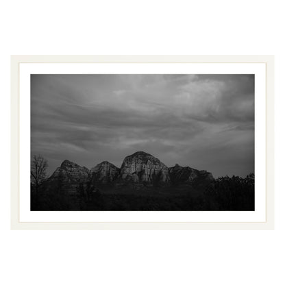 Black and white photograph of mountains in Sedona Arizona at night in a white frame with white mat