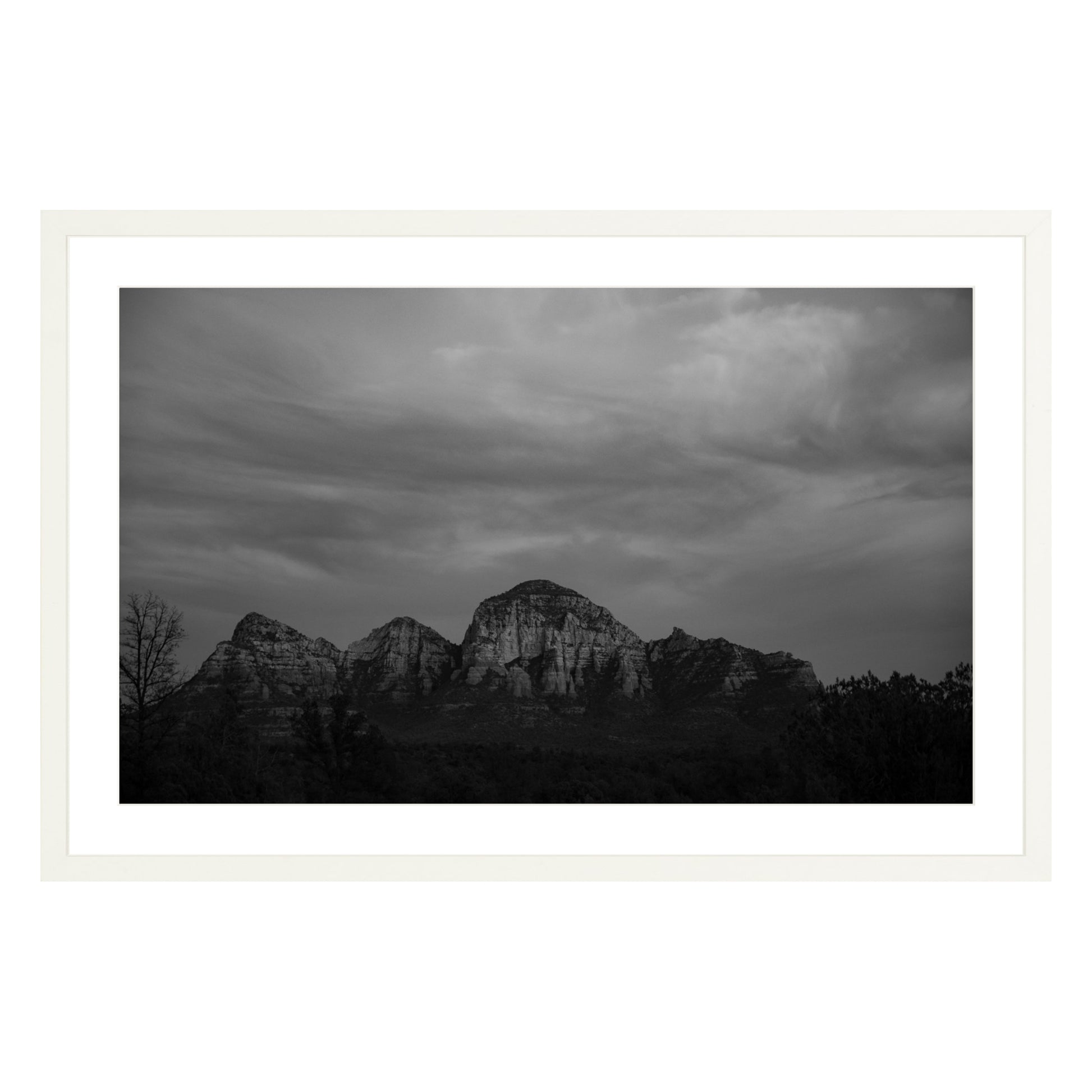 Black and white photograph of mountains in Sedona Arizona at night in a white frame with white mat