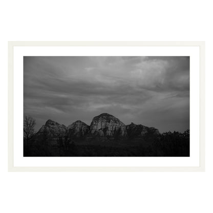 Black and white photograph of mountains in Sedona Arizona at night in a white frame with white mat