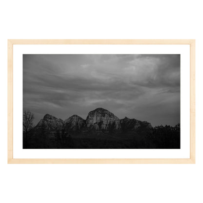Black and white photograph of mountains in Sedona Arizona at night in a natural wood frame with white mat