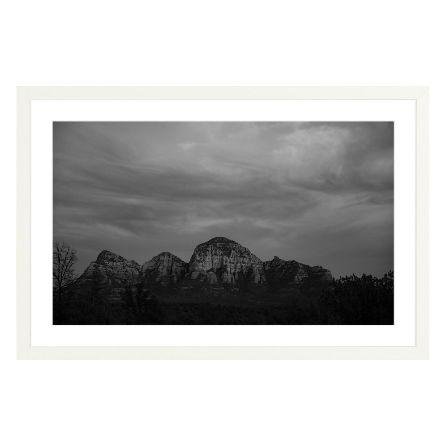 Black and white photograph of mountains in Sedona Arizona at night in a white frame with white mat
