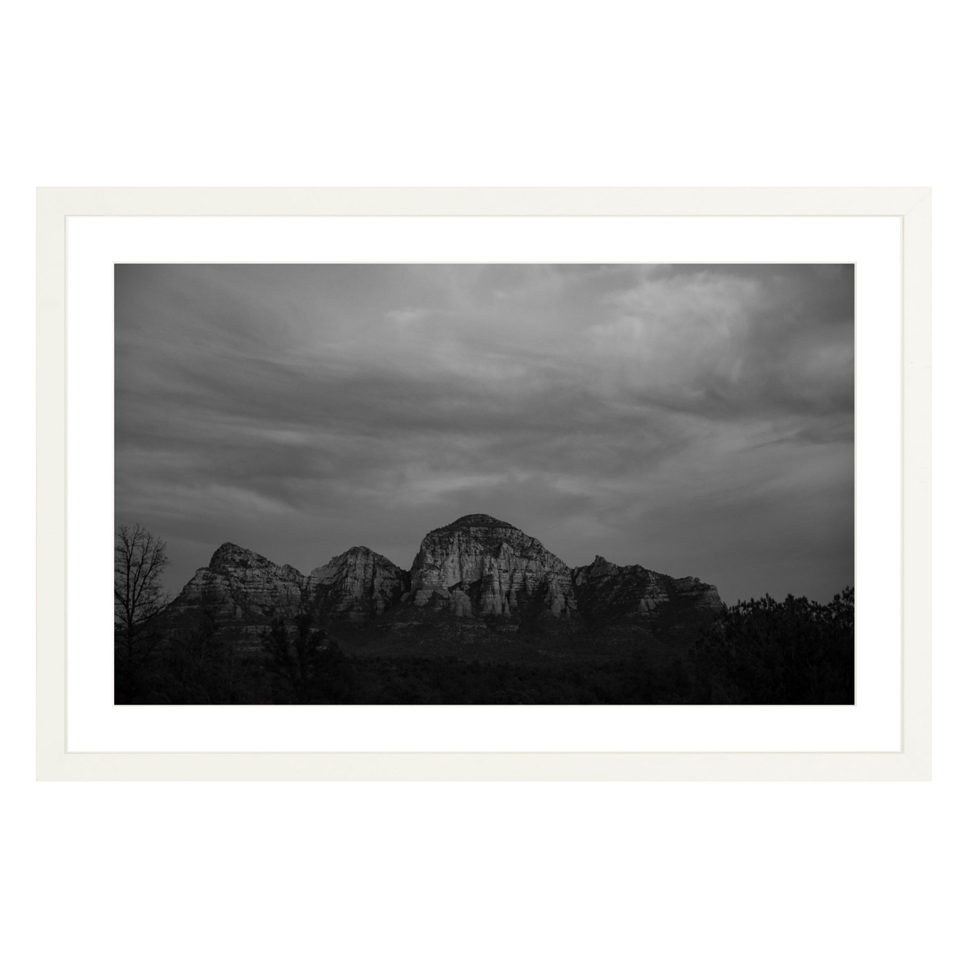 Black and white photograph of mountains in Sedona Arizona at night in a white frame with white mat