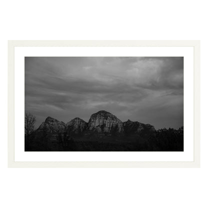 Black and white photograph of mountains in Sedona Arizona at night in a white frame with white mat